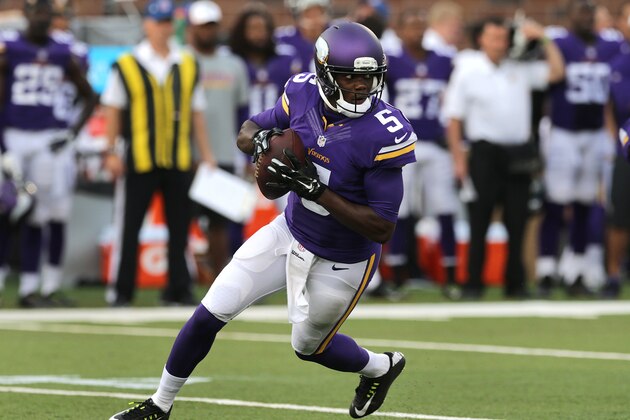 Minnesota Vikings quarterback Teddy Bridgewater (5) rolls out against the Oakland Raiders in the first half of a preseason NFL football game in Minneapolis, Friday, Aug. 8, 2014. (AP Photo/Jim Mone)