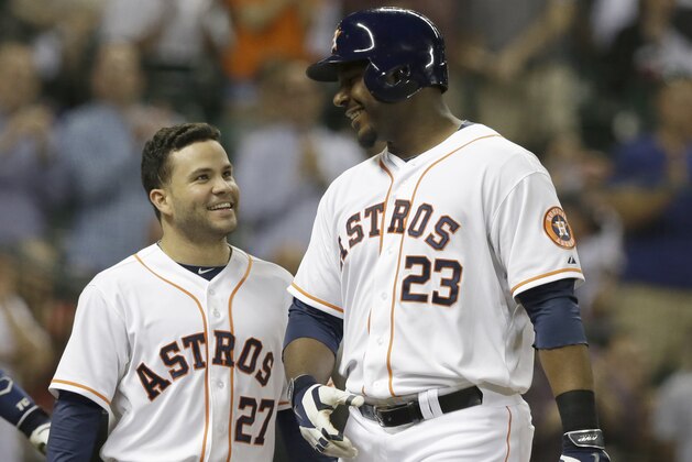 Houston Astros Jose Altuve (27)  and Chris Carter (23) after scoring on Carter's 3-run homer against the Minnesota Twins in the fifth inning of a baseball game Tuesday, Aug. 12, 2014, in Houston. (AP Photo/Pat Sullivan)