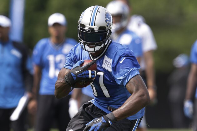Detroit Lions wide receiver Calvin Johnson runs after a catch during a NFL football training camp in Allen Park, Mich., Tuesday, July 29, 2014. (AP Photo/Paul Sancya)