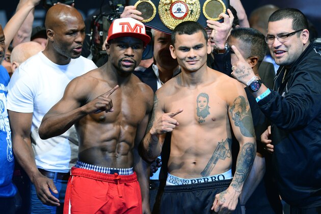 LAS VEGAS, NV - MAY 02:  (L-R) WBA/IBF light heavyweight champion Bernard Hopkins looks on as WBC welterweight champion Floyd Mayweather Jr. and WBA champion Marcos Maidana pose as Maidana's cousin Pileta Maidana gestures during their official weigh-in at the MGM Grand Garden Arena on May 2, 2014 in Las Vegas, Nevada. Mayweather and Maidana will meet in a WBC/WBA unification fight in Las Vegas on May 3.  (Photo by Ethan Miller/Getty Images)