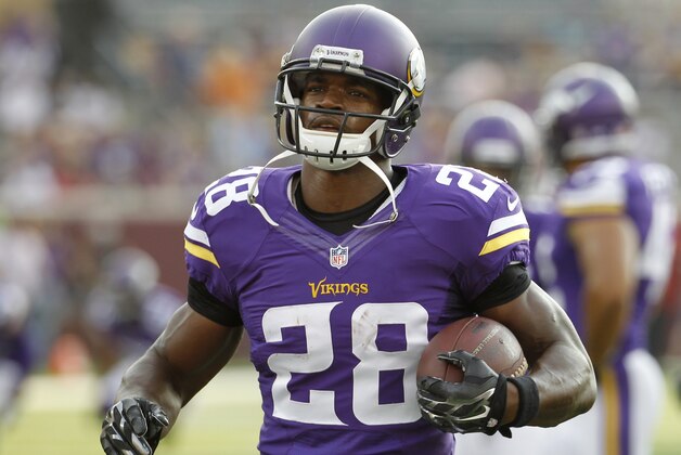 Minnesota Vikings running back Adrian Peterson (28) warms up before an NFL preseason football game against the Arizona Cardinals, Saturday, Aug. 16, 2014, in Minneapolis. (AP Photo/Ann Heisenfelt)
