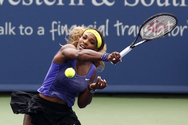 Serena Williams returns a volley to Caroline Wozniacki, from Denmark, during a semifinal match at the Western & Southern Open tennis tournament, Saturday, Aug. 16, 2014, in Mason, Ohio. Williams won 2-6, 6-2, 6-4. (AP Photo/David Kohl)