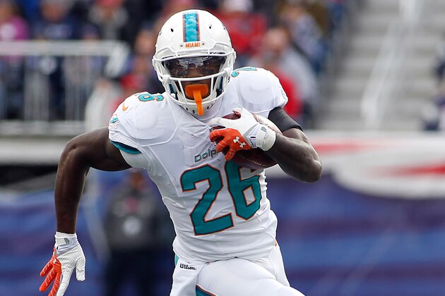 Oct 27, 2013; Foxborough, MA, USA; Miami Dolphins running back Lamar Miller (26) runs against the New England Patriots during the first quarter at Gillette Stadium. Mandatory Credit: Stew Milne-USA TODAY Sports