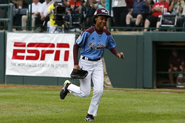 Pennsylvania pitcher Mo'ne Davis celebrates after getting the final out of a 4-0 shutout against Tennessee during a baseball game in United States pool play at the Little League World Series tournament in South Williamsport, Pa., Friday, Aug. 15, 2014. (AP Photo/Gene J. Puskar)