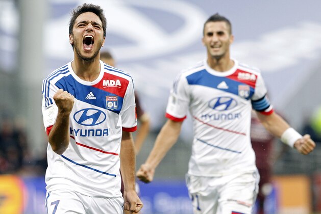 Lyon's Clement Grenier, left, celebrates with Maxime Gonalons, right, after he scored a goal against Valenciennes during their French League One soccer match at Gerland stadium, in Lyon, central France, Saturday, Sept. 1, 2012. (AP Photo/Laurent Cipriani)