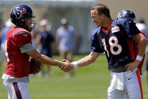 Houston Texans quarterback Ryan Fitzpatrick (14) and Denver Broncos quarterback Peyton Manning (18) shake hands following a joint practice between the Denver Broncos and the Houston Texans on Wednesday, Aug. 20, 2014, in Englewood, Colo. (AP Photo/Jack Dempsey)