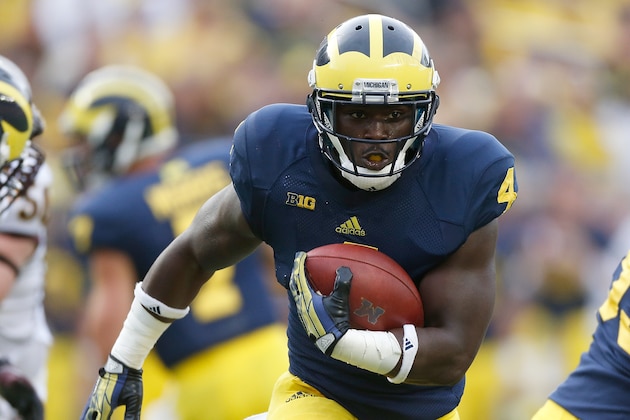 ANN ARBOR, MI - AUGUST 31: De'Veon Smith #4 of the Michigan Wolverines looks for extra yards during a fourth quarter run while playing the Central Michigan Chippewas at Michigan Stadium on August 31, 2013 in Ann Arbor, Michigan. Michigan won the 59-9. (Photo by Gregory Shamus/Getty Images)