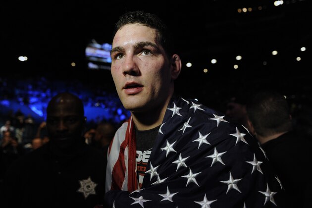 Chris Weidman, of Baldwin, N.Y., walks after defeating Anderson Silva, of Brazil, during the UFC 168 mixed martial arts middleweight championship bout on Saturday, Dec. 28, 2013, in Las Vegas. Weidman won during the second round by a technical knockout after Silva was injured. (AP Photo/David Becker)