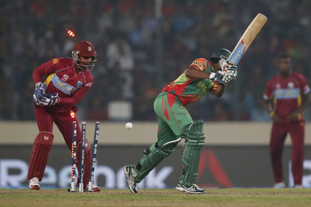 Bangladesh batsman Shakib Al Hasan, center, is bowled out by West Indies' bowler Krishmar Santokie during their ICC Twenty20 Cricket World Cup match in Dhaka, Bangladesh, Tuesday, March 25, 2014. (AP Photo/Aijaz Rahi) Bangladesh batsman Shakib Al Hasan, center, is bowled out by West Indies' bowler Krishmar Santokie during their ICC Twenty20 Cricket World Cup match in Dhaka, Bangladesh, Tuesday, March 25, 2014. (AP Photo/Aijaz Rahi)