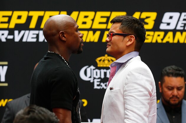 NEW YORK, NY - JULY 14:  Marcos Maidana and Floyd Mayweather Jr. face-off during a news conference at the Pedestrian Walk in Times Square on July 14, 2014 in New York City. Floyd Mayweather Jr. and Marcos Maidana are scheduled to fight September 13, 2014 at the MGM Grand in Las Vegas.  (Photo by Mike Stobe/Getty Images)