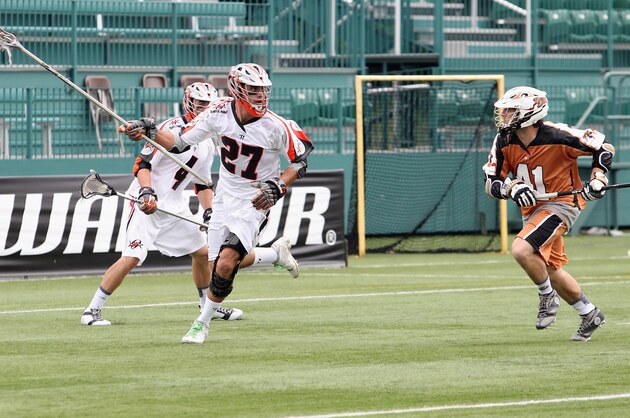 ROCHESTER, NY - JUNE 29: Ken Clausen #27 of the Denver Outlaws carries the ball against Mark Cockerton #41 of the Rochester Rattlers at Sahlen's Stadium on June 29, 2014 in Rochester, New York. Rochester defeated Denver 19-14.  (Photo by Jen Fuller/Getty Images)
