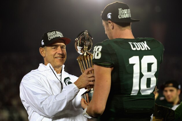 PASADENA, CA - JANUARY 01:  Michigan State Spartans head coach Mark Dantonio and quarterback Connor Cook #18 celebrate with the Rose Bowl Game trophy after defeating the Stanford Cardinal 24-20 in the 100th Rose Bowl Game presented by Vizio at the Rose Bowl on January 1, 2014 in Pasadena, California.  (Photo by Harry How/Getty Images)