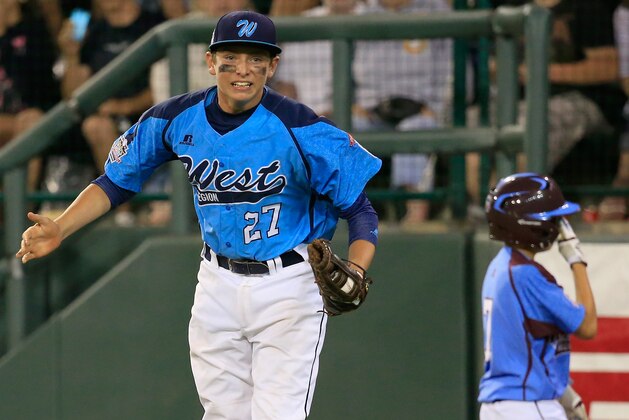 SOUTH WILLIAMSPORT, PA - AUGUST 20:  Brennan Holligan #27  of Nevada celebrates after forcing out a Pennsylvania batter for the third out of the fourth inning during the United States division game at the Little League World Series tournament at Lamade Stadium on August 20, 2014 in South Williamsport, Pennsylvania.  (Photo by Rob Carr/Getty Images)