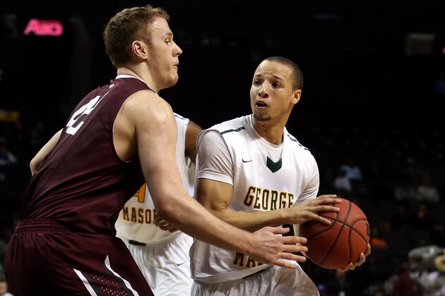 NEW YORK, NY - MARCH 12: Patrick Holloway #3 of the George Mason Patriots handles the ball against Ryan Canty #42 of the Fordham Rams in the second half during the first round of the Atlantic 10 Men's Basketball Tournament at Barclays Center on March 12, 2014 in the Brooklyn Borough of New York City.  (Photo by Mike Lawrie/Getty Images)