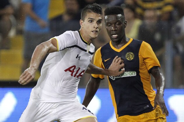 Erik Lamela of Tottenham, left, control the ball by Diallo Guidileye, right, of AEL during their Europa League play-offs first leg soccer match at Antonis Papadopoulos stadium in Larnaca, Cyprus, Thursday, Aug. 21, 2014. Tottenham won the match 2-1. (AP Photo/Petros Karadjias)