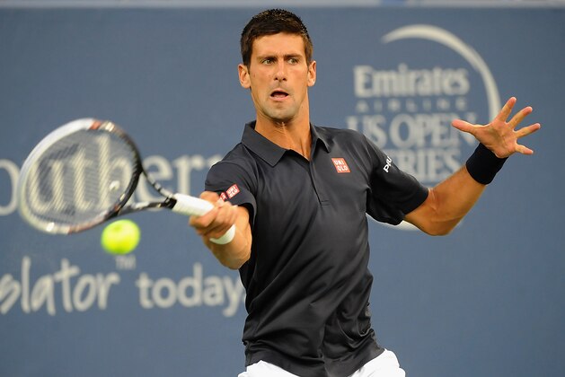 CINCINNATI, OH - AUGUST 12:  Novak Djokovic of Serbia returns to Gilles Simon of France during a match on day 4 of the Western & Southern Open on August 12, 2014 in Cincinnati, Ohio.  (Photo by Jonathan Moore/Getty Images)