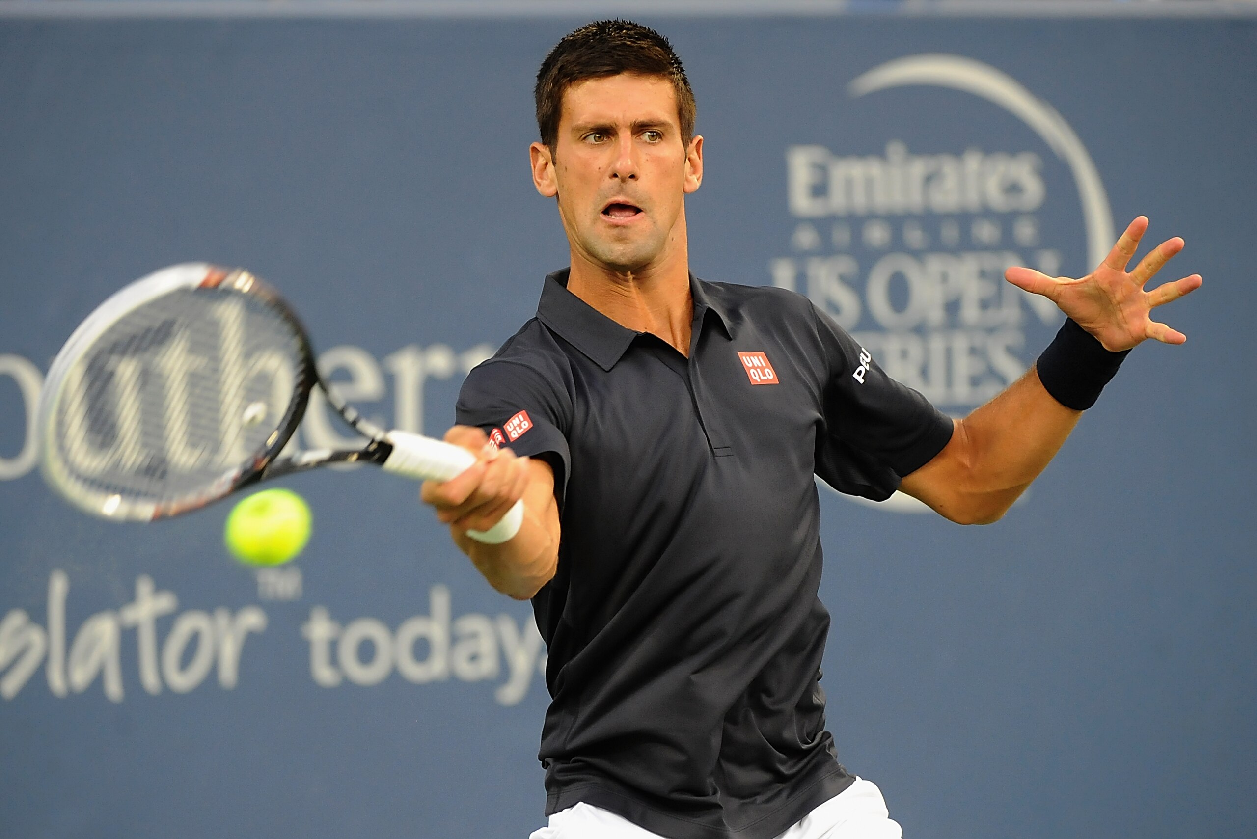 CINCINNATI, OH - AUGUST 12:  Novak Djokovic of Serbia returns to Gilles Simon of France during a match on day 4 of the Western & Southern Open on August 12, 2014 in Cincinnati, Ohio.  (Photo by Jonathan Moore/Getty Images)