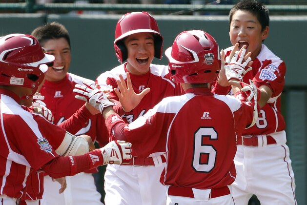 Japan's Hayato Ueshima (6) is greeted by teammates after hitting a solo home run off Mexico's Erick Vela in the first inning of an International elimination baseball game at the Little League World Series tournament in South Williamsport, Pa.,  Thursday, Aug. 21, 2014. (AP Photo/Gene J. Puskar