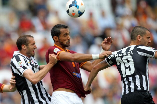 ROME, ITALY - MAY 11: Giorgio Chiellini(L) and Leonardo Bonucci of Juventus competes for the ball with Mehdi Benatia(C) of AS Roma during the Serie A match between AS Roma and Juventus at Stadio Olimpico on May 11, 2014 in Rome, Italy.  (Photo by Paolo Bruno/Getty Images)