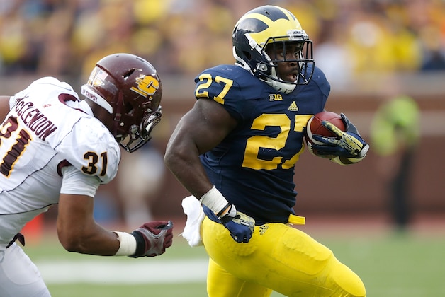 ANN ARBOR, MI - AUGUST 31: Derrick Green #27 of the Michigan Wolverines tries to get around the tackle of Kenny McClendon #31 of the Central Michigan Chippewas during a fourth quarter run at Michigan Stadium on August 31, 2013 in Ann Arbor, Michigan.  (Photo by Gregory Shamus/Getty Images)
