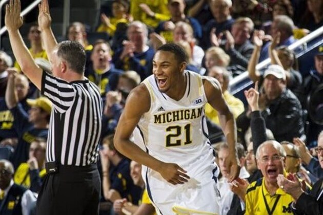 Michigan guard Zak Irvin (21) celebrates a 3-point basket in the first half of an NCAA college basketball game against Nebraska in Ann Arbor, Mich., Wednesday, Feb. 5, 2014. (AP Photo/Tony Ding)