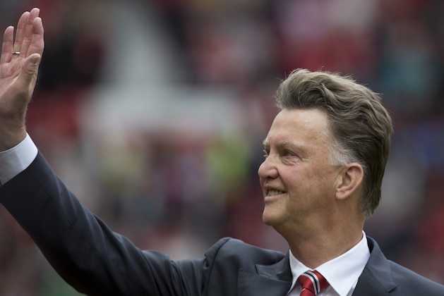 Manchester United's new manager Louis van Gaal  waves to supporters before his team's English Premier League soccer match against Swansea City at Old Trafford Stadium, Manchester, England, Saturday Aug. 16, 2014. (AP Photo/Jon Super)