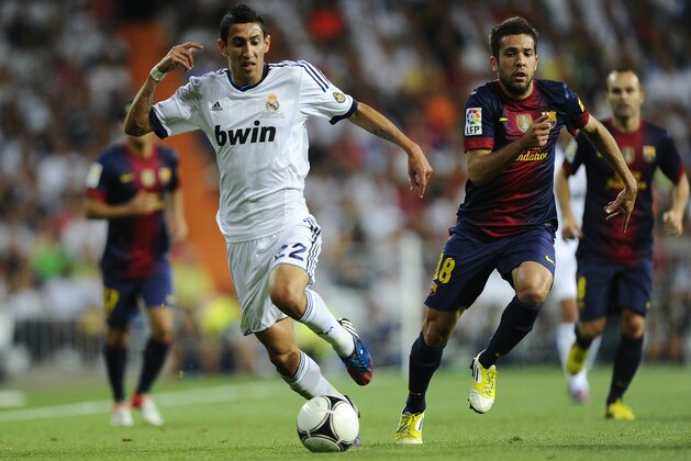 MADRID, SPAIN - AUGUST 29:  Angel Di Maria of Real Madrid CF (L) duels for the ball with Jordi Alba of FC Barcelona during the Super Cup second leg match betwen Real Madrid and FC Barcelona at Estadio Santiago Bernabeu on August 29, 2012 in Madrid, Spain.  (Photo by David Ramos/Getty Images)