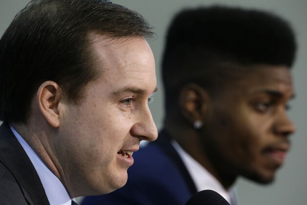 Philadelphia 76ers general manager Sam Hinkie, left,  accompanied by newly acquired rookie Nerlens Noel speaks during a news conference at the team's NBA basketball training facility, Tuesday, July 23, 2013, in Philadelphia. (AP Photo/Matt Rourke)