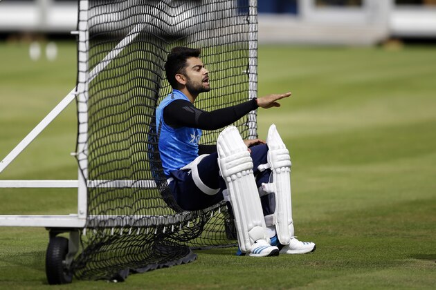 India's Virat Kohli speaks to a teammate as he waits his turn to bat in the nets during a training session at Lord's cricket ground in London, Tuesday, July 15, 2014.  India are due to play England in the second cricket test match of the series at Lord's starting on Thursday.  (AP Photo/Matt Dunham)