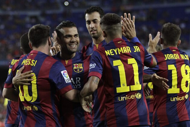 Barcelona's Lionel Messi from Argentina, left, celebrates with teammates scoring the opening goal during the Joan Gamper trophy friendly soccer match between Barcelona and Leon at the Camp Nou stadium in Barcelona, Spain, Monday, Aug. 18, 2014. (AP Photo/Emilio Morenatti)