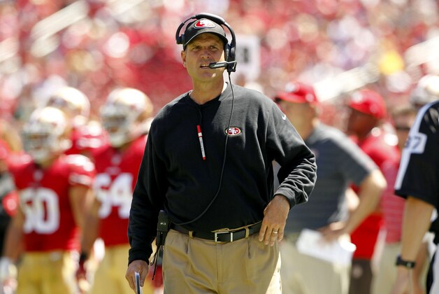 Aug 17, 2014; Santa Clara, CA, USA; San Francisco 49ers head coach Jim Harbaugh walks on the field before calling a timeout against the Denver Broncos in the second quarter at Levi's Stadium. Mandatory Credit: Cary Edmondson-USA TODAY Sports
