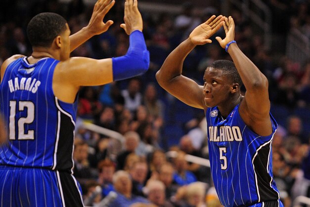 Mar 28, 2014; Orlando, FL, USA; Orlando Magic guard Victor Oladipo (5) and forward Tobias Harris (12) celebrate after Harris drew a foul in overtime as the Magic beat the Charlotte Bobcats 110-105 at Amway Center. Mandatory Credit: David Manning-USA TODAY Sports