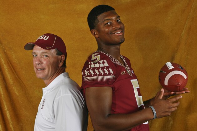 Florida State head coach Jimbo Fisher, left, and quarterback Jameis Winston (5) pose for a photo during their NCAA college football media day on Sunday, Aug. 10, 2014, in Tallahassee, Fla. Florida State starts its quest for back-to-back national championships Aug. 30 when they open against Oklahoma State in Arlington, Tex. (AP Photo/Phil Sears)