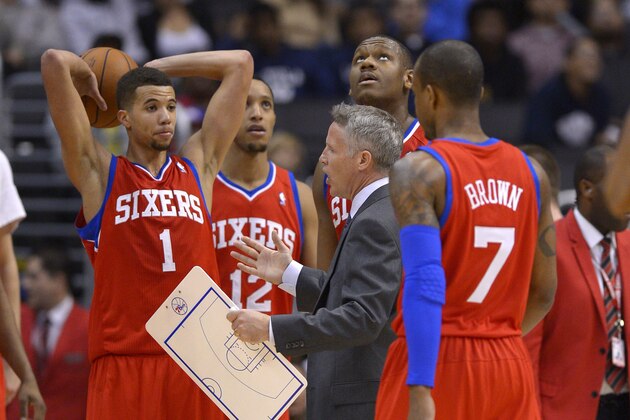 Philadelphia 76ers head coach Brett Brown, center, talks to his team as Lavoy Allen, second from right, looks up toward the scoreboard and Michael Carter-Williams, left, Evan Turner, second from left, and Lorenzo Brown look on during the second half of an NBA basketball game, Sunday, Feb. 9, 2014, in Los Angeles. The Clippers won 123-78.  (AP Photo/Mark J. Terrill)