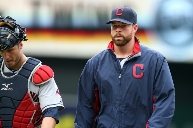 Cleveland Indians starting pitcher Corey Kluber, right, heads to the dugout with catcher Yan Gomes before the first inning of a baseball game, Thursday, Aug. 21, 2014, in Minneapolis. (AP Photo/Jim Mone)