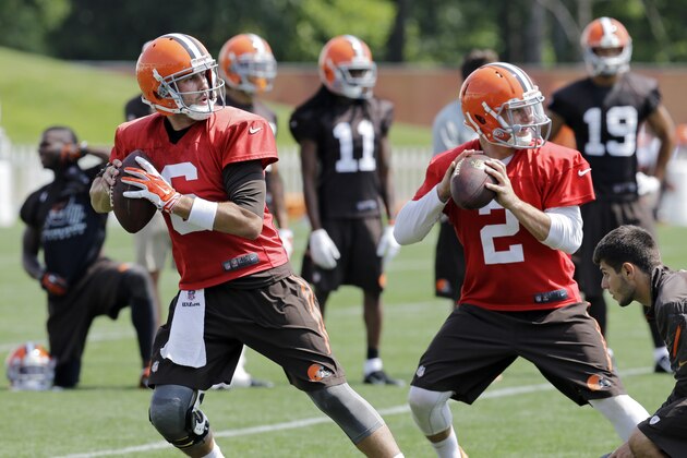 Cleveland Browns quarterback Brian Hoyer (6) and Johnny Manziel (2) drop to pass during practice at the NFL football team's facility in Berea, Ohio Wednesday, Aug. 20, 2014. (AP Photo/Mark Duncan)