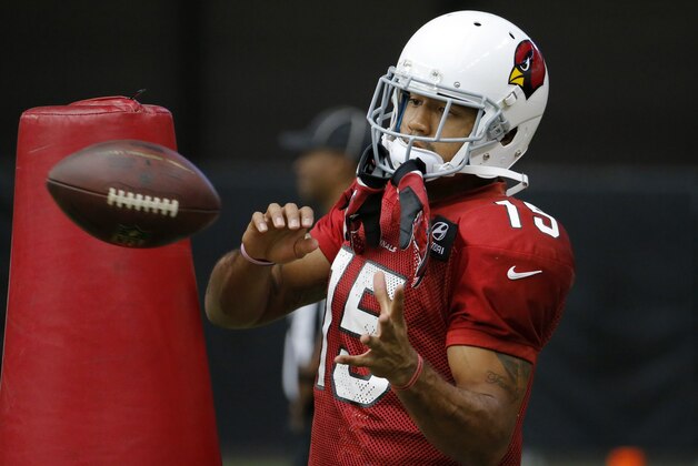 Arizona Cardinals receiver Michael Floyd makes a catch during an NFL football training camp, Tuesday, July 29, 2014, in Glendale, Ariz. (AP Photo/Matt York)
