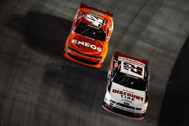 BRISTOL, TN - AUGUST 22:  Ryan Blaney, driver of the #22 Discount Tire Ford, leads Kyle Larson, driver of the #42 ENEOS Chevrolet, during the NASCAR Nationwide Series Food City 300 at Bristol Motor Speedway on August 22, 2014 in Bristol, Tennessee.  (Photo by Rainier Ehrhardt/Getty Images)