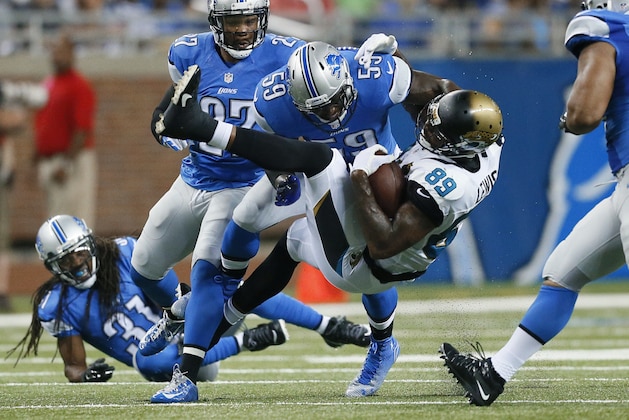Jacksonville Jaguars tight end Marcedes Lewis (89) is brought down by Detroit Lions linebacker Tahir Whitehead (59) in the first half of a preseason NFL football game at Ford Field in Detroit, Friday, Aug. 22, 2014. (AP Photo/Rick Osentoski)