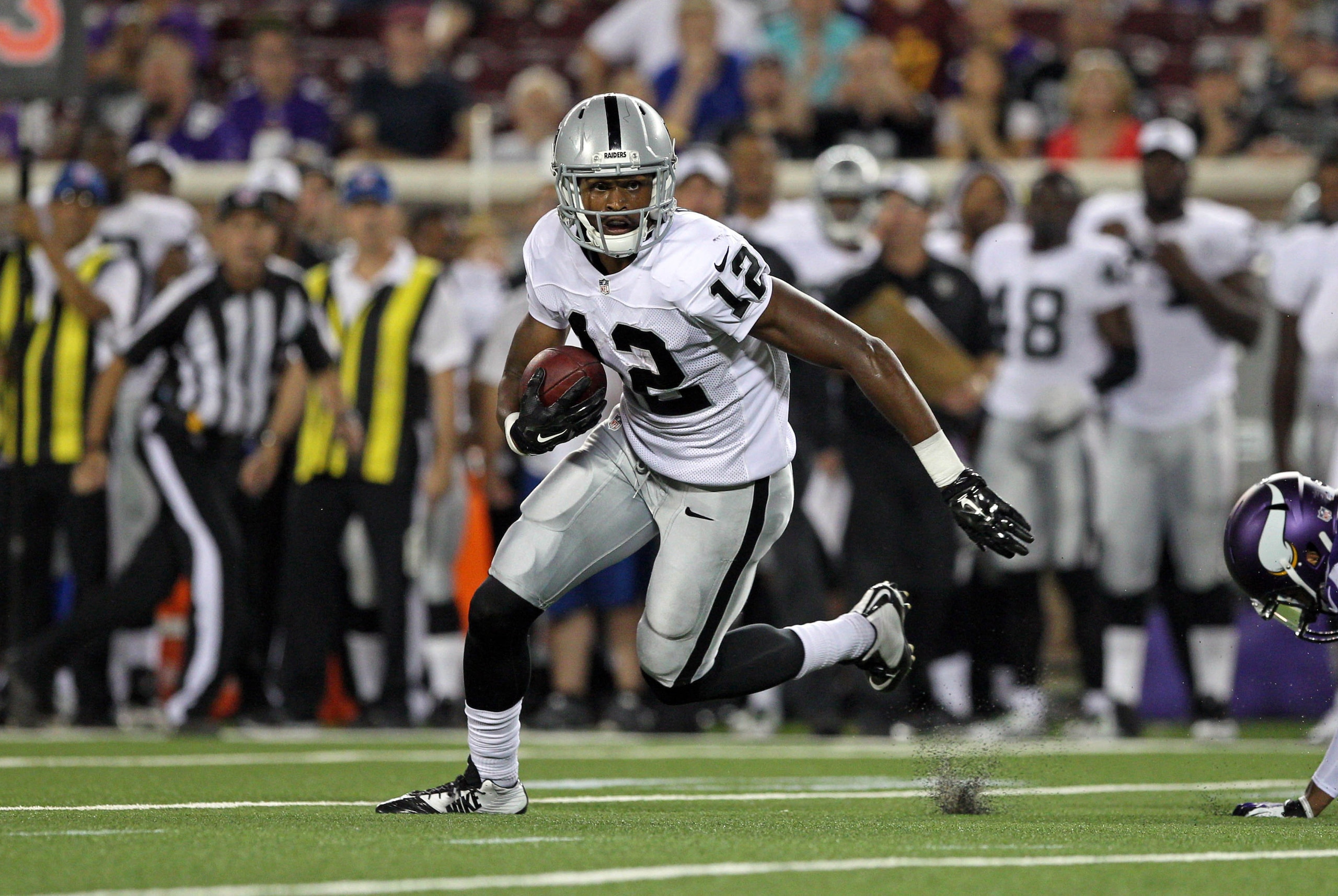 Aug 8, 2014; Minneapolis, MN, USA; Oakland Raiders wide receiver Brice Butler (12) carries the ball during the fourth quarter against the Minnesota Vikings at TCF Bank Stadium. The Vikings defeated the Raiders 10-6. Mandatory Credit: Brace Hemmelgarn-USA TODAY Sports