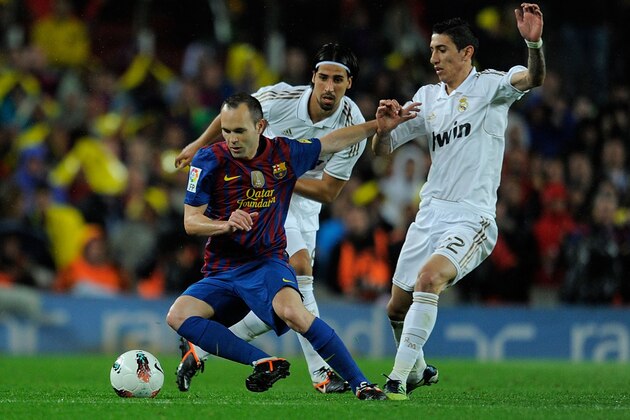 BARCELONA, SPAIN - APRIL 21: Andres Iniesta (L) of FC Barcelona battles for the ball against Angel di Maria (R) and Sami Khedira of Real Madrid CF during the La Liga match between FC Barcelona and Real Madrid CF at Camp Nou on April 21, 2012 in Barcelona, Spain.  (Photo by Denis Doyle/Getty Images)