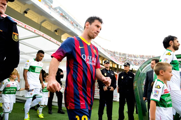 ELCHE, SPAIN - MAY 11:  Lionel Messi of FC Barcelona walks onto the pitch prior to the La Liga match between Elche FC and FC Barcelona at Estadio Manuel Martinez Valero on May 11, 2014 in Elche, Spain.  (Photo by David Ramos/Getty Images)