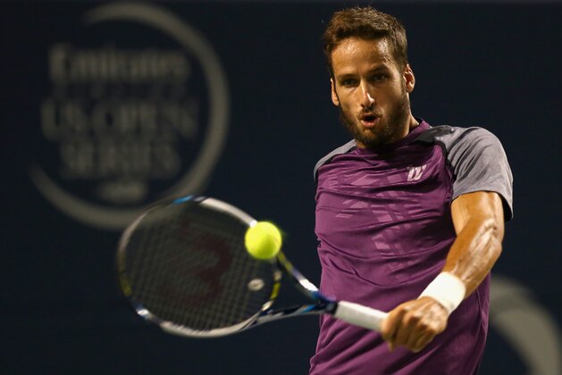 TORONTO, ON - AUGUST 09:  Feliciano Lopez of Spain returns a shot to Roger Federer of Switzerland in the semifinals during Rogers Cup at Rexall Centre at York University on August 9, 2014 in Toronto, Canada.  (Photo by Ronald Martinez/Getty Images)