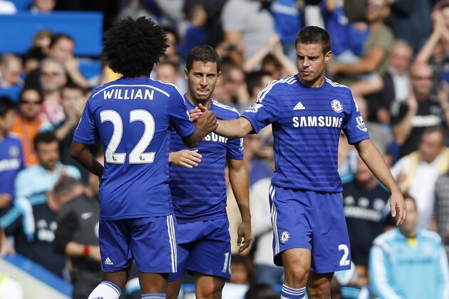 Chelsea's Eden Hazard, center, celebrates his goal against Leicester City with teammates during their English Premier League soccer match at Stamford Bridge, London, Saturday, Aug. 23, 2014. (AP Photo/Sang Tan)