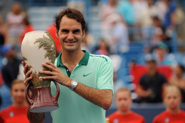 CINCINNATI, OH - AUGUST 17:  Roger Federer of Switzerland poses with the winner's trophy after a final match against David Ferrer of Spain on day 9 of the Western & Southern Open at the Linder Family Tennis Center on August 17, 2014 in Cincinnati, Ohio.  (Photo by Jonathan Moore/Getty Images)