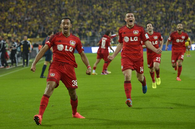 Leverkusen's Karim Bellarabi, left, celebrates during the German Bundesliga soccer match between Borussia Dortmund and Bayer Leverkusen in Dortmund,  Germany, Saturday, Aug. 23, 2014. Borussia was defeated by Bayer with 0-2. (AP Photo/Martin Meissner)