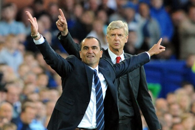 Everton's manager Roberto Martínez, left, and Arsenal's manager Arsene Wenger react during the English Premier League soccer match between Everton and Arsenal at Goodison Park, in Liverpool, England, Saturday, Aug. 23, 2014. (AP Photo/Rui Vieira)