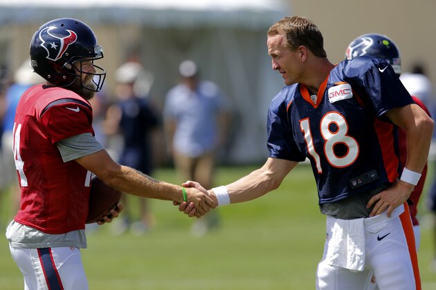 Houston Texans quarterback Ryan Fitzpatrick (14) and Denver Broncos quarterback Peyton Manning (18) shake hands following a joint practice between the Denver Broncos and the Houston Texans on Wednesday, Aug. 20, 2014, in Englewood, Colo. (AP Photo/Jack Dempsey)