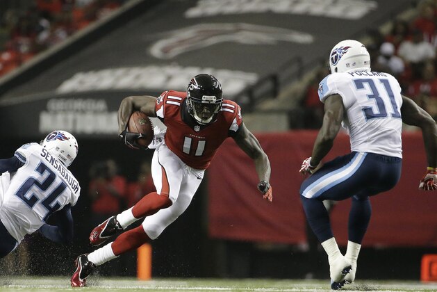 Atlanta Falcons wide receiver Julio Jones (11) runs against Tennessee Titans strong safety Bernard Pollard (31) during the first half of an NFL preseason football game, Saturday, Aug. 23, 2014, in Atlanta. Jones scored a touchdown on the play. (AP Photo/David Goldman)