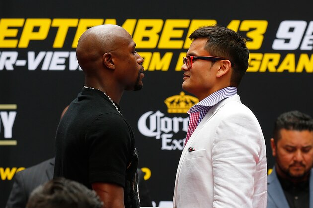 NEW YORK, NY - JULY 14:  Marcos Maidana and Floyd Mayweather Jr. face-off during a news conference at the Pedestrian Walk in Times Square on July 14, 2014 in New York City. Floyd Mayweather Jr. and Marcos Maidana are scheduled to fight September 13, 2014 at the MGM Grand in Las Vegas.  (Photo by Mike Stobe/Getty Images)